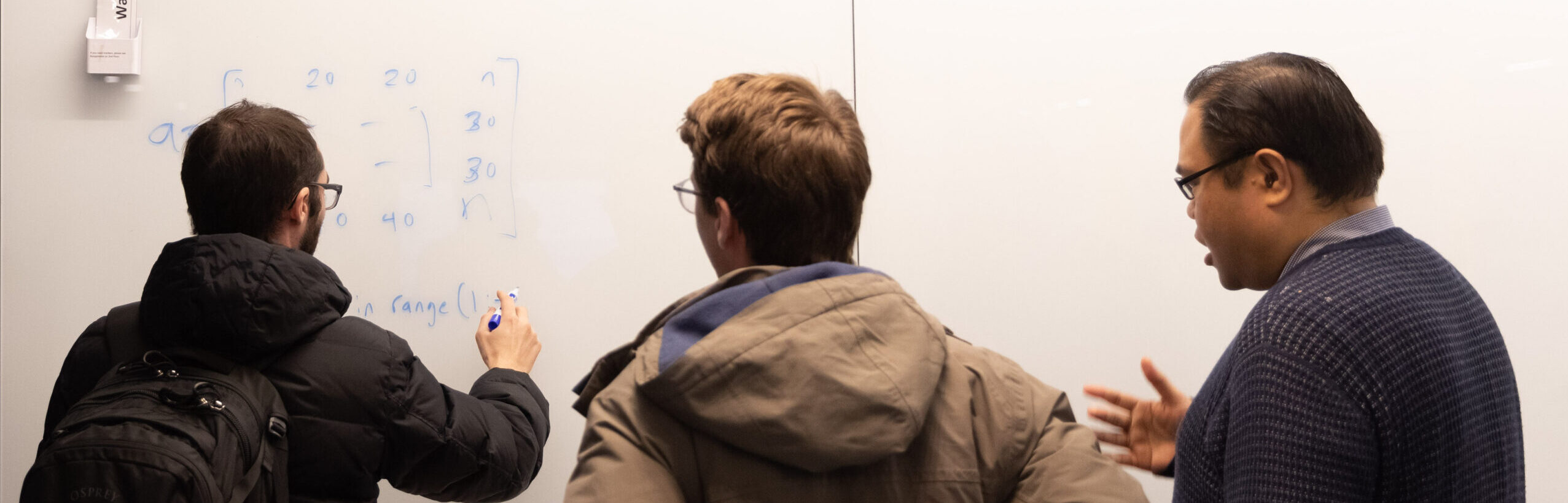 CAPP students writing on whiteboard