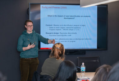 Assistant Professor Fiona Burlig speaking to students